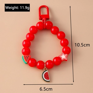 Detailed view of red beaded keychain with watermelon charm and star pendant accents