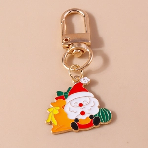 Detailed close-up of a golden Christmas Santa Claus keychain with high-quality enamel finish