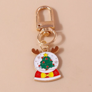 Detailed close-up of a Christmas tree keychain with golden hook and enamel snowflake globe
