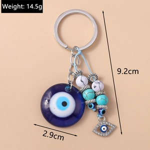 Detail view of the evil eye keychain showing dimensions 9.2cm length and 2.9cm diameter