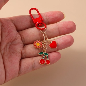 Fashion red cherry heart flower keychain with carabiner on beige background