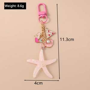 Detailed view of starfish and mermaid keychain with product dimensions and weight