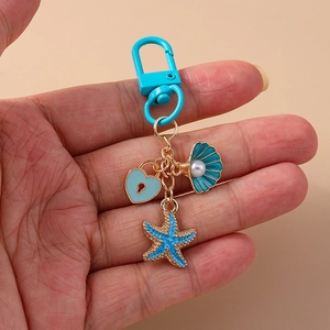 Blue heart and sea shell keychain with star charms and pearl on gold-plated alloy