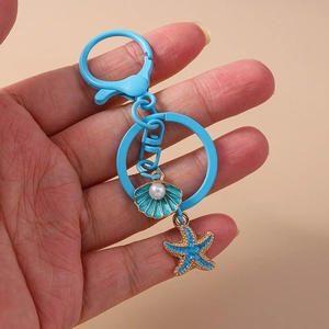 Blue seashell and starfish keychain with pearl and gold trim for backpack decor