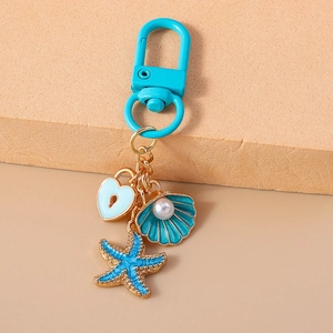 Detail of nautical keychain with sky blue starfish, seashell, and heart charms
