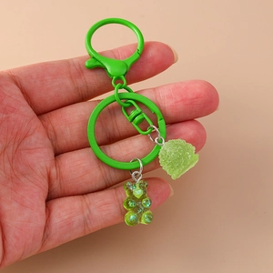 Green cartoon gummy bear keychain with matching metal ring and textured ball charm