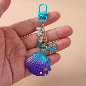 Ocean theme keychain featuring purple shell, blue starfish, and mermaid charms