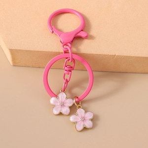 Pink cherry blossom keychain with gold-edged flower charms and metal lobster clasp