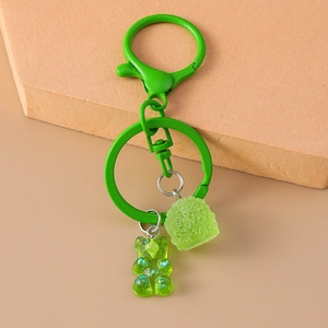 Detail showing green glitter gummy bear charm with metal lobster clasp and key ring