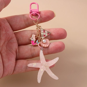Pink ocean theme keychain with mermaid star and shell charms on golden link chain