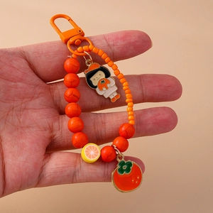 Orange beaded fruit keychain featuring cute cartoon girl, persimmon and citrus pendants