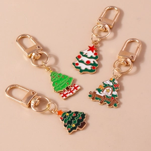 Detailed close-up of gold plated Christmas tree keychains with festive enamel designs