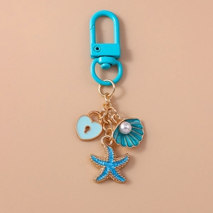 Detail of ocean theme keychain with blue heart, pearl shell and starfish pendants