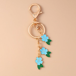 Detailed view of blue enamel cherry blossom charms with golden alloy lobster clasp