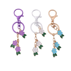 Three-piece cherry blossom keychain set in purple white and blue enamel floral pendants