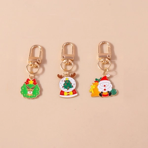 Detailed view of colorful Christmas keychains with Santa and Reindeer on gold alloy