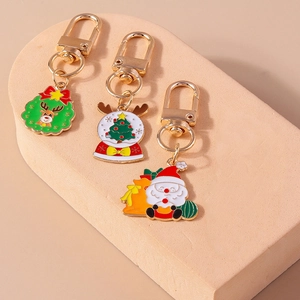 Three-piece Christmas keychain set featuring Santa and Reindeer on stone display