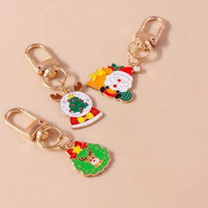 Detail view of colorful Christmas enamel charms featuring Santa Claus and reindeer on golden hooks