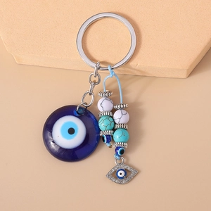 Detailed macro of Evil Eye keychain with blue glass pendant and turquoise marble beads