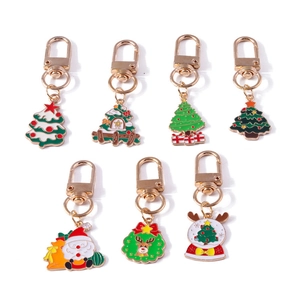 Set of Christmas enamel keychains including Santa, reindeer, and decorated trees