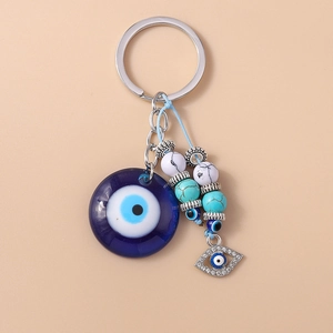 Detail of Turkish Evil Eye keychain with turquoise beads and silver moon pendant