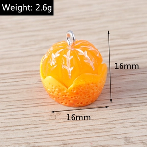 Macro shot of resin orange charm with lifelike fruit texture and silver metal loop
