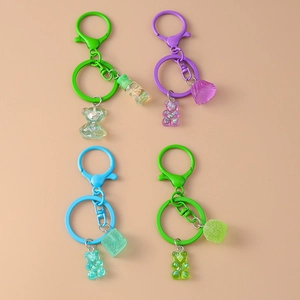 Colorful sugar-cube bear keychains in green, purple, and blue with glitter finish