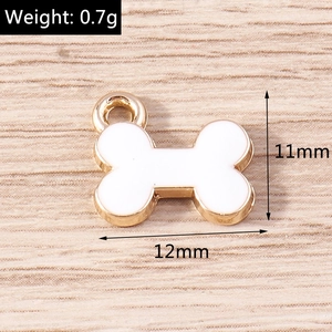 Detail view of bone shaped alloy charm with white enamel and size markings 12x11mm