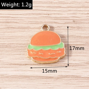 Macro view of burger enamel charm with size and weight specs on wooden background