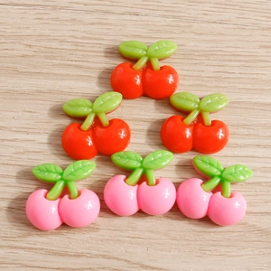 Macro shot of 3D resin cherry charms for DIY crafts and phone case decoration