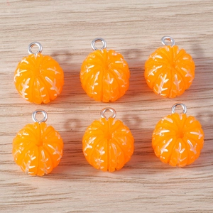 Macro detail of six orange resin tangerine pendants with realistic sugar frost texture