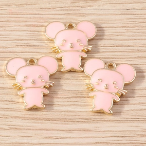 Three pink enamel cartoon mouse pendants on wood background for DIY jewelry making