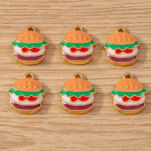 Detailed view of six miniature colorful burger enamel charms for DIY jewelry crafting