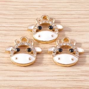 Three cute cow pendants with white enamel and sparkling rhinestones for DIY jewelry