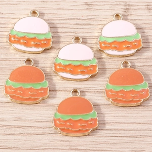 Detailed macro view of colorful enamel hamburger pendants with golden metal loops for DIY