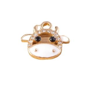 Cute golden cow pendant with white enamel and sparkling rhinestones for DIY jewelry