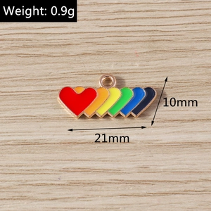 Macro shot of 21mm rainbow enamel heart pendant with golden alloy base for DIY jewelry