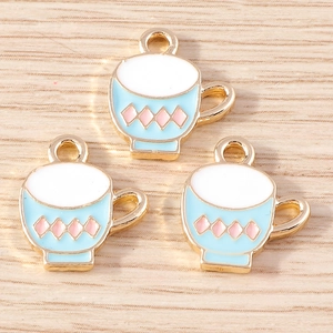 Close-up of blue cartoon tea cup charms with gold plating for DIY jewelry making
