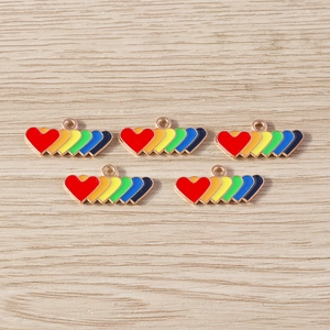 Close-up of rainbow enamel heart alloy charms with rose gold finish for DIY jewelry