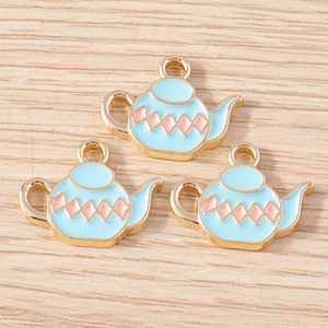 Detailed view of light blue teapot charms with pink diamond pattern for DIY jewelry