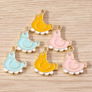 DIY cartoon chick enamel pendants in assorted colors for jewelry making on wood background
