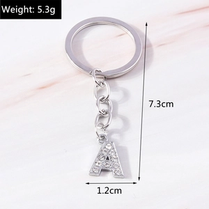Macro shot of silver letter A keychain with rhinestones showing dimensions and weight