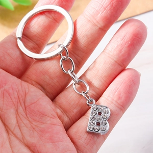 Macro shot of silver letter B keychain pendant with sparkling crystal rhinestones