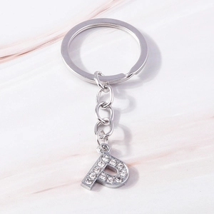 Macro shot of a silver letter P keychain featuring shimmering clear crystal embellishments