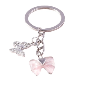 Eleganter Schmetterling-Schlüsselanhänger mit rosa Schleife und funkelnden Kristallen