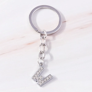 Macro view of silver-tone keychain with sparkling rhinestone-inlaid letter W pendant