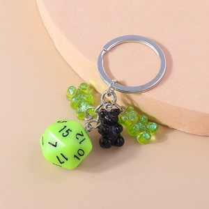Creative keychain featuring neon green polyhedral dice and translucent resin bear charms