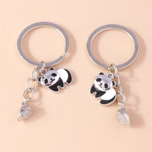 Detail view of cute magnetic panda keychains with enamel finish and silver metal rings