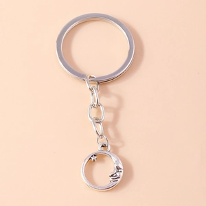 Classic silver moon and star keychain with detailed crescent face on neutral background