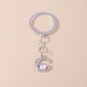 Futuristic silver crescent moon keychain with iridescent bead and sparkling crystals